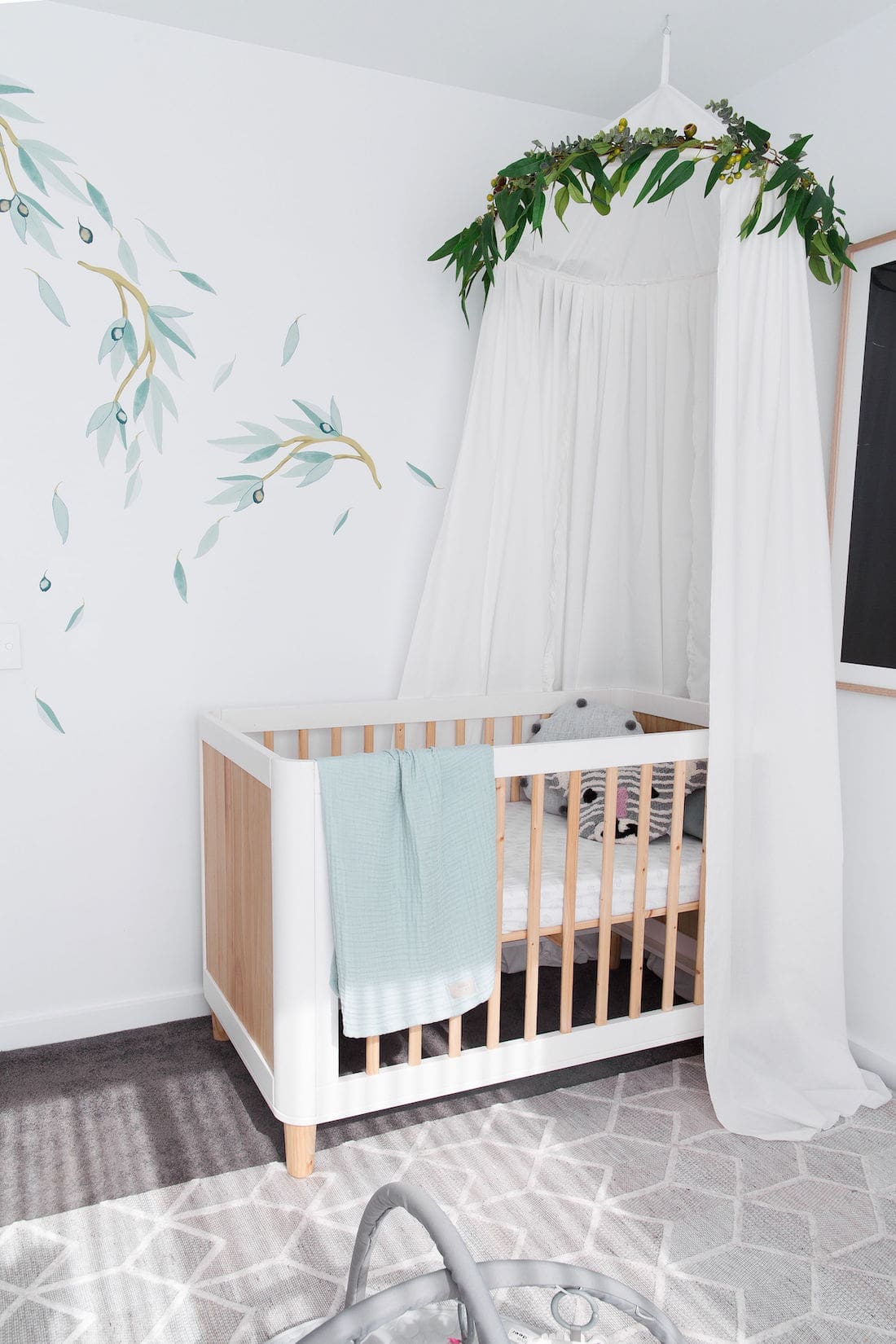 Cot canopy and eucalyptus removable wall decals in Australian inspired nursery