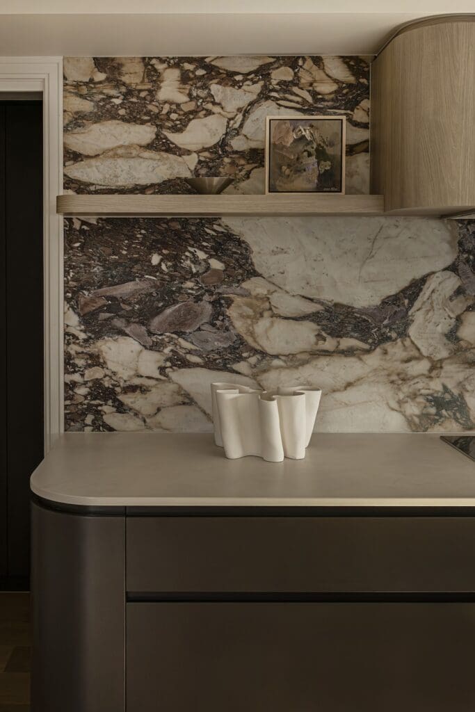 Natural stone backsplash in kitchen of Deakin Home