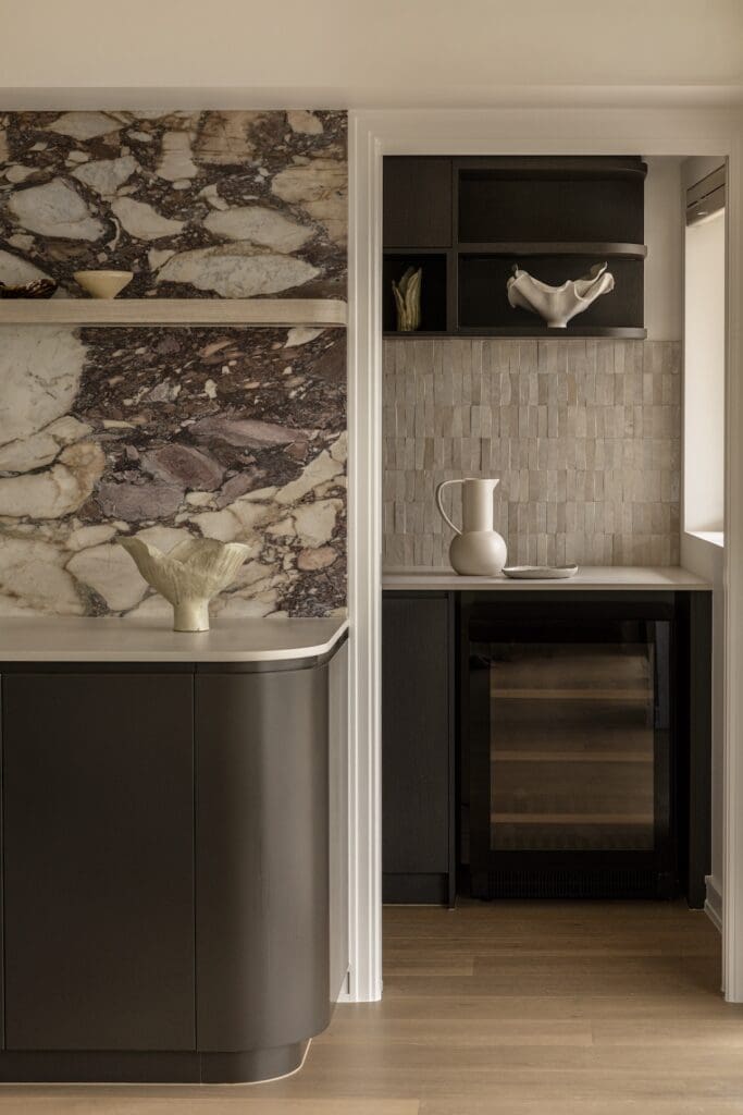 Stone backsplash in kitchen through to walk in pantry in Deakin Home