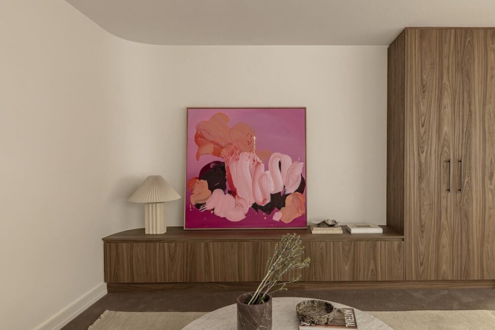 Pink artwork with curved wall in living room at Deakin Home