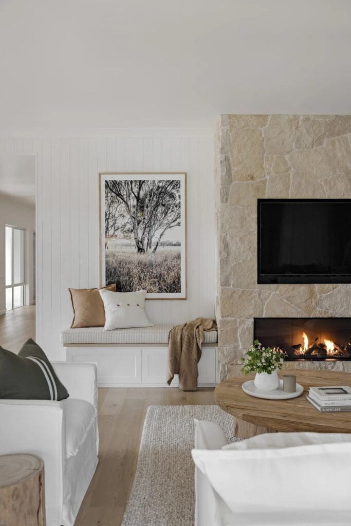 Fireplace and bench seat in living room of Ewingsdale home