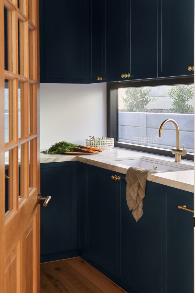 Navy butler’s pantry with brass tap and marble benchtop