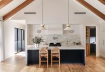 Modern farmhouse kitchen with timber beams and marble splashback