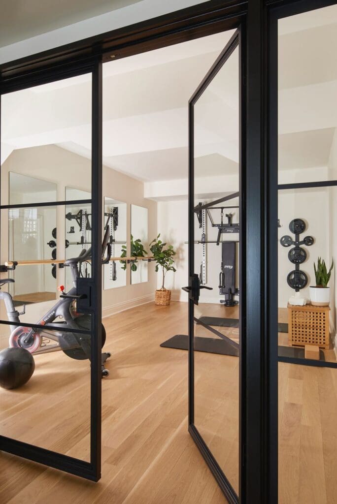 Home gym behind glass partition doors