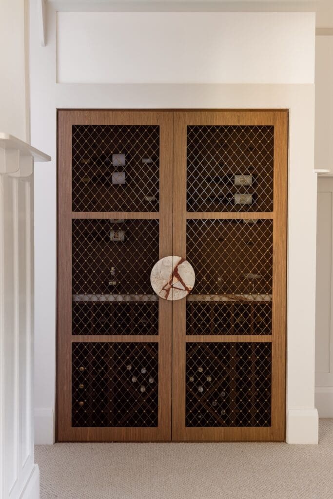 Wine room behind custom doors with round store door handles