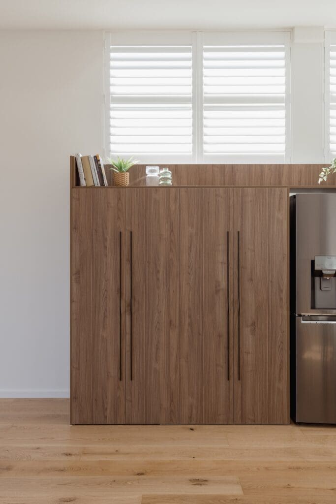 Kitchen pantry cabinetry with long black handles