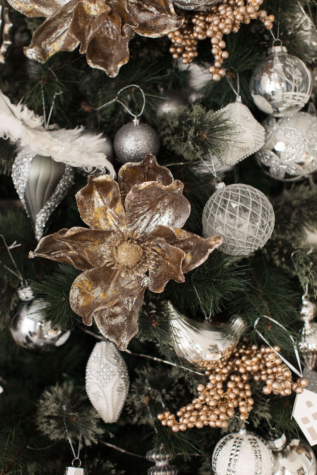 Magnolia flower and other tree picks fill out the look of your Christmas tree