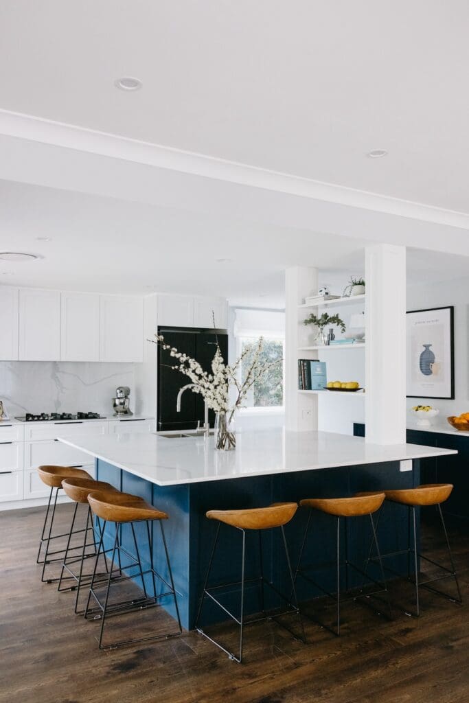 Modern large family kitchen with blue joinery and marble splashback