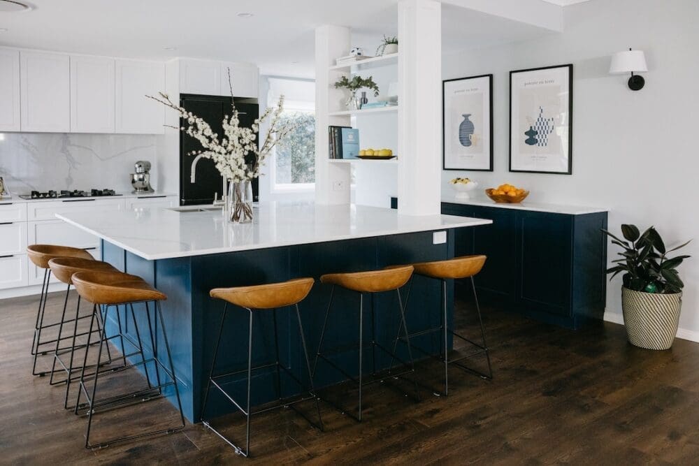 Deep blue kitchen island in a white kitchen