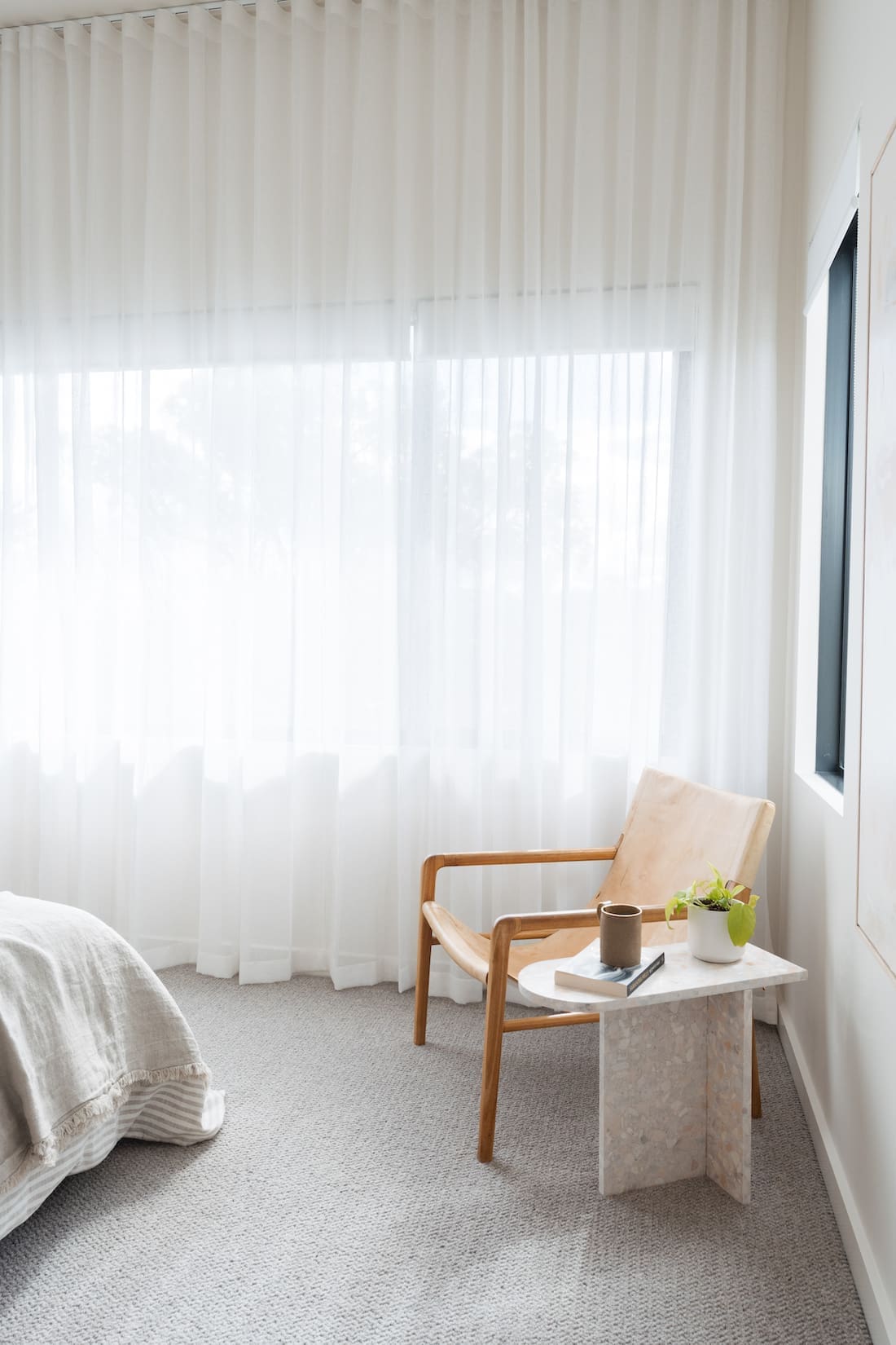 Sheer curtain add softness in a minimalist modern bedroom