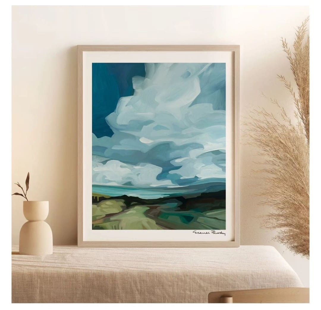 Framed landscape painting with abstract sky clouds