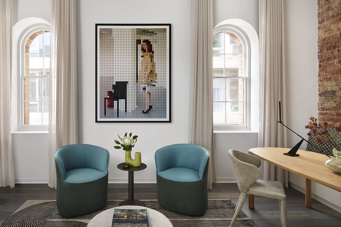 Teal occasional chairs in living room of Tribeca Brewery apartment by The Stylesmiths