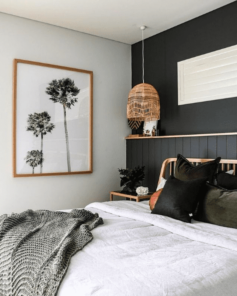 Black feature wall in bedroom with built-in shelf